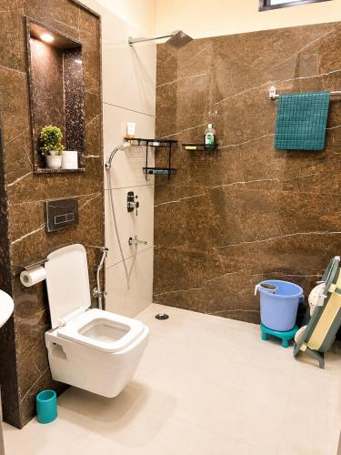 a bathroom with a toilet and a shower at Entire 3BHK Villa for Families & Groups with Kids Play Area in Jaipur