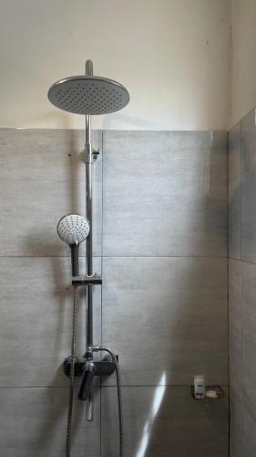 a bathroom with a shower with a glass wall at Judewin villa Negombo in Negombo