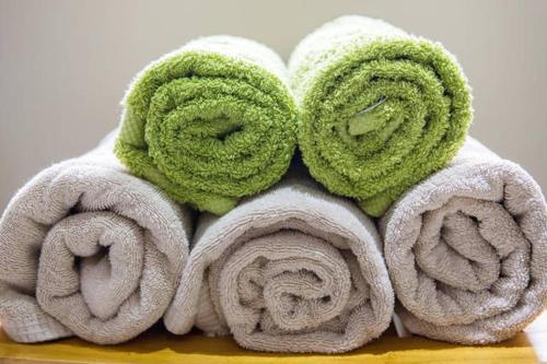 a pile of towels sitting on a table at Glanmor Garden Apartment in Swansea