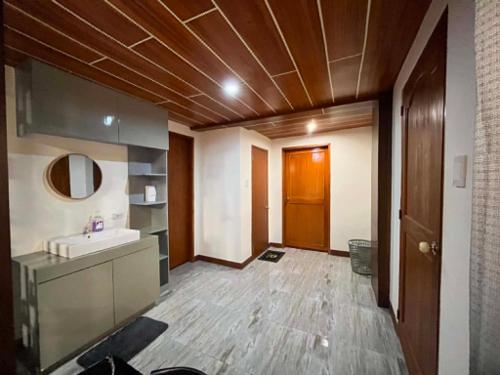 a bathroom with a sink and a mirror at BalikBalik Villa in El Nido