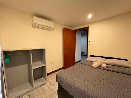 a bedroom with a bed and a air conditioner at BalikBalik Villa in El Nido