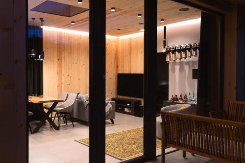 a living room with a television and a table at Kabata 2620 ` Кабата 2620 in Bansko