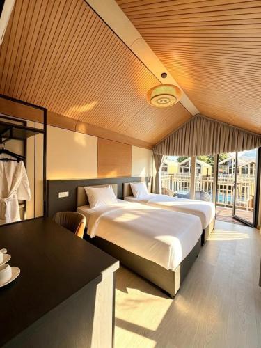 a hotel room with two beds and a table at All Season Resort Semporna in Semporna