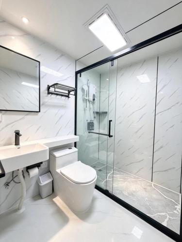 a bathroom with a shower and a toilet and a sink at All Season Resort Semporna in Semporna