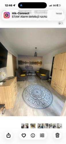 a living room with a couch and a table at APARTAMENT PLUS in Włodawa
