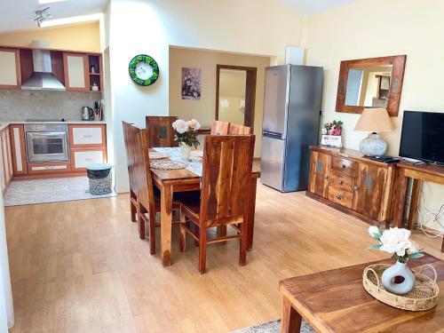 a kitchen with a dining table and a refrigerator at Balchik English House in Balchik
