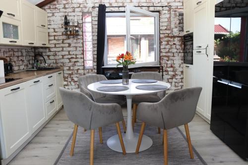 a kitchen with a table and chairs in a kitchen at Kuća za odmor Leon in Vinkovci