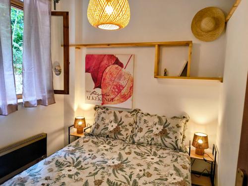 a bedroom with a bed and two lamps and a window at Tiny home in Camigliatello Silano