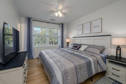 a bedroom with a bed and a dresser and a television at Bethany Beach Retreat with Pool - VTC in Frankford