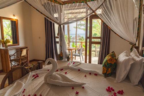 a bedroom with a bed with flowers on it at Tunu Beach Zanzibar in Kizimkazi