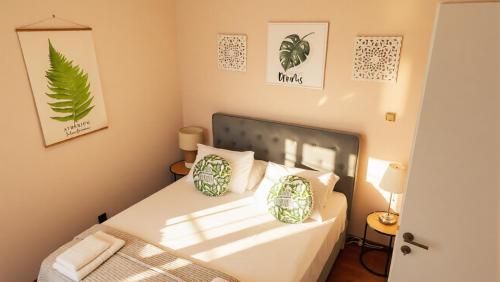 a bedroom with a bed with white sheets and pillows at Moustakias Villa in Kefallonia