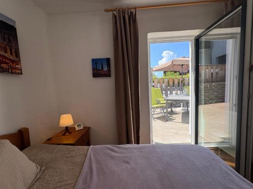 a bedroom with a bed and a view of a patio at Ferienwohnung Heissl in Fieberbrunn