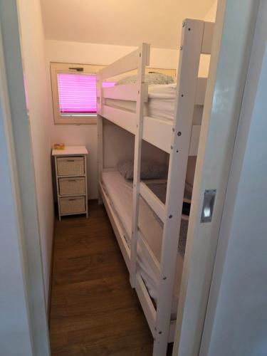two bunk beds in a small room with a desk at Spa Cottage Lavender in Terme Čatež in Čatež ob Savi