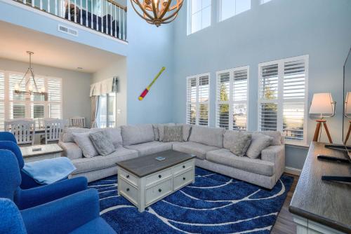a living room with a gray couch and blue chairs at Villa at Greys Neck - Close to Bethany Beach in Millville