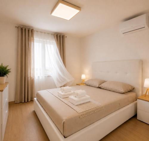 a bedroom with a bed with two towels on it at Palazzo Solera Rooms in Casarano