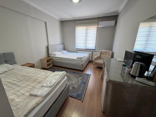 a bedroom with a bed and a couch and a desk at Korkmaz Rezidans in Kayseri