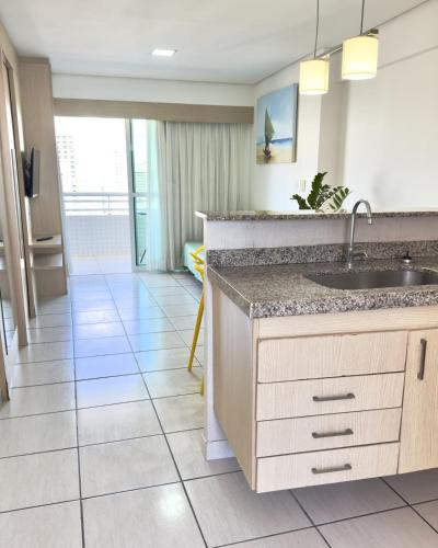 a kitchen with a sink and a tile floor at VIP Beira Mar Residence in Fortaleza