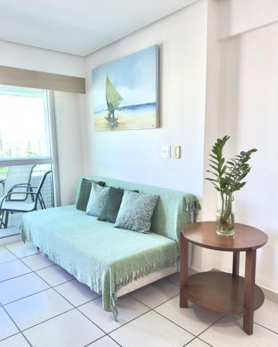 a living room with a couch and a table at Beach Class Exclusive in Fortaleza