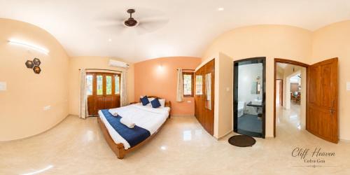 a large bedroom with a bed and a bathroom at Cliff Heaven in Colva