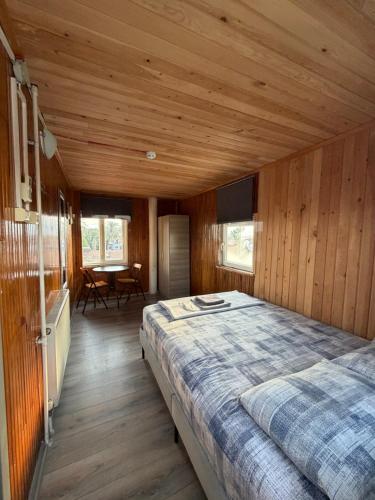 a bedroom with a large bed in a wooden room at Erkal Pension in Antalya