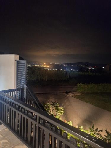 a balcony with a view of a city at night at Vista Apartment With Hot Tub & Large Terrace in Leskovec pri Krškem
