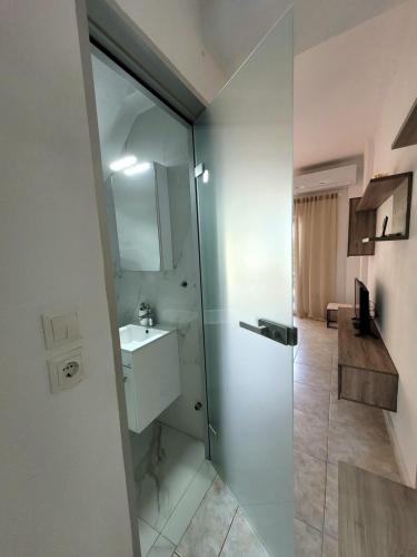 a bathroom with a glass shower and a sink at Anris & Dianas Dom - In a quiet part of the center in Kallithea Halkidikis