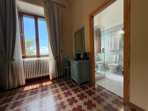 a bathroom with a shower and a sink and a toilet at Hotel Villa Porta All'Arco in Volterra