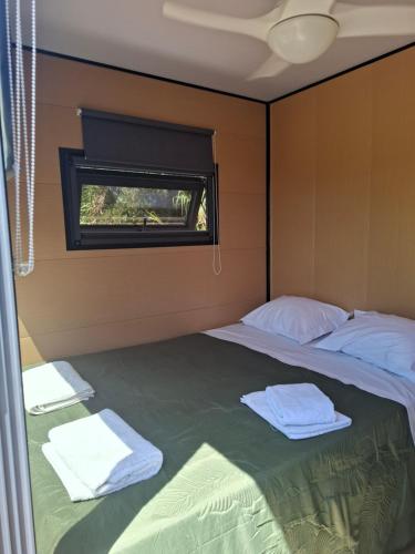 a bedroom with two beds and a window at FALCOARIA Eco in Setúbal