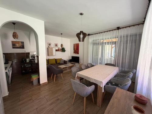 a living room with a table and a couch at Mária Villa in Balatonmáriafürdő