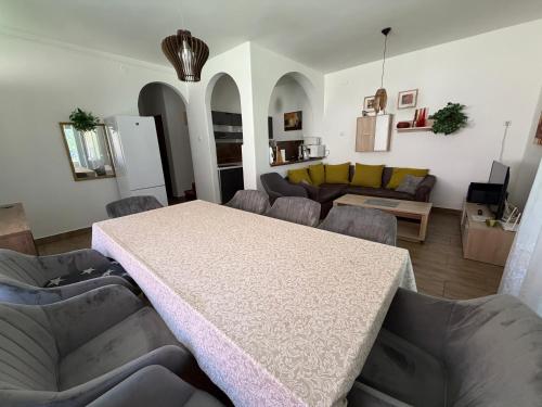 a living room with a table and a couch at Mária Villa in Balatonmáriafürdő