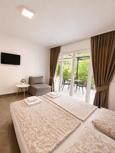 a bedroom with two beds and a living room at Villa Stefanoski in Konsko