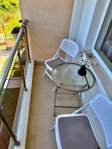 a balcony with a table and chairs and a window at SOLITA Apartment with Panoramic View in Byala