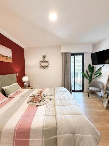 a bedroom with a large bed with a towel on it at Villa Bavaria B in Ponta do Sol
