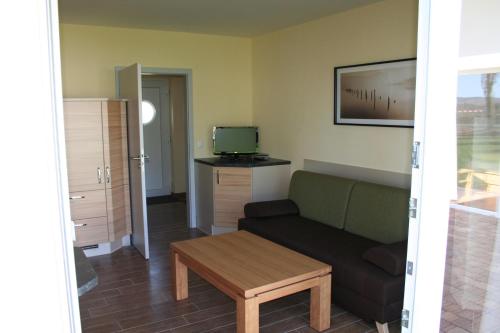 a living room with a couch and a table at Pension am Sundhäuser See in Nordhausen