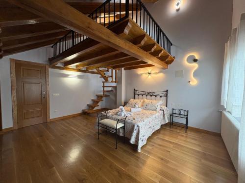 a bedroom with a bed and a wooden floor at La Casona El Carrascal in La Gandara
