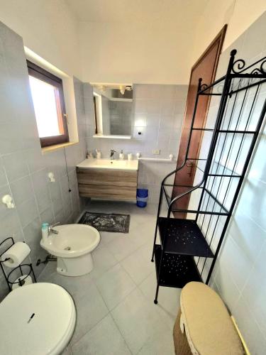 a bathroom with a toilet and a sink at Leoncorno la Marina a Villasimius in Villasimius