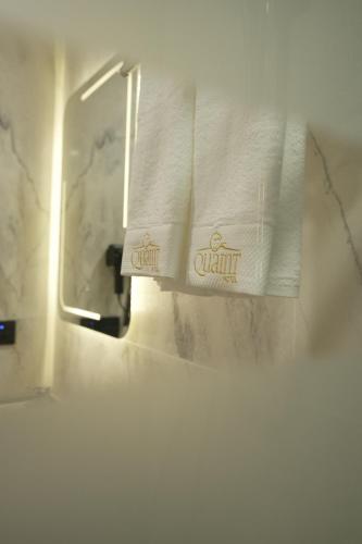 a bathroom with a white towel on a towel rack at Quaint Hotel Erbil in Erbil