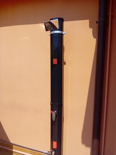 a refrigerator with a brush on the side of it at Garda City Home Family Apartments in Garda