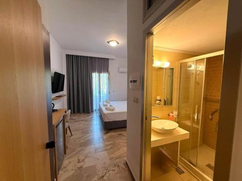a bathroom with a sink and a toilet in a room at Lili Hotel in Amoudara Herakliou
