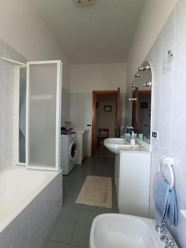 a bathroom with a sink and a washing machine at Tra mare e vigneti in Ortona
