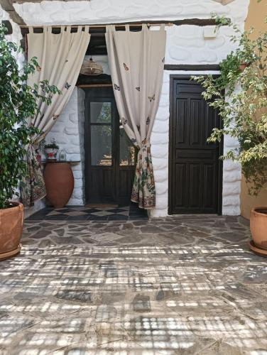 an entrance to a house with a door with curtains at Casas Amaro in Órgiva