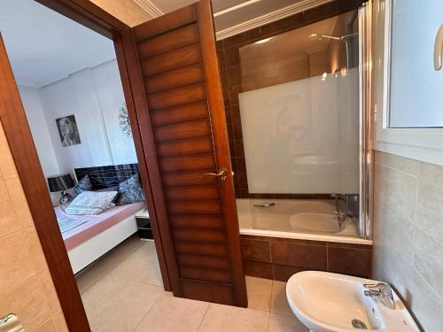 a bathroom with a sink and a shower and a toilet at Altos Bahia Magic in Torrevieja