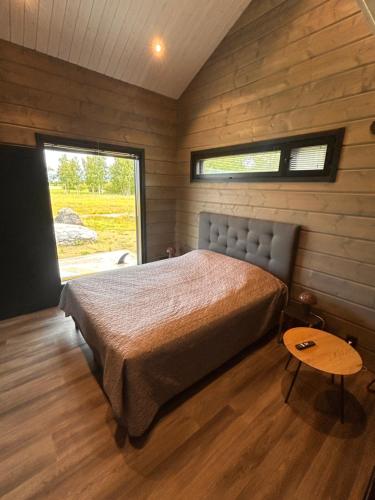 a bedroom with a bed in a room with a window at Sea Haven Villa in Trutberget