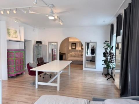 a living room with a white table and a couch at Wohnstudio Millstatt in Millstatt