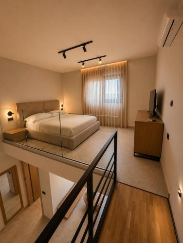 a bedroom with a bed and a glass table at Estia Luxury Suites & Spa in Platamonas