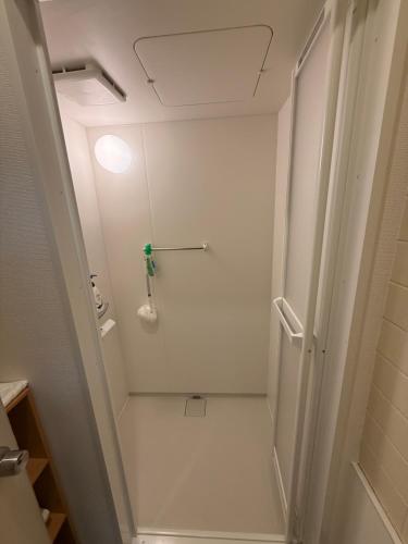 a bathroom with a shower and a toilet in it at Roxy inn in Oita