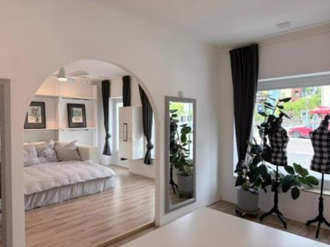 a living room with a bed and a mirror at Wohnstudio Millstatt in Millstatt
