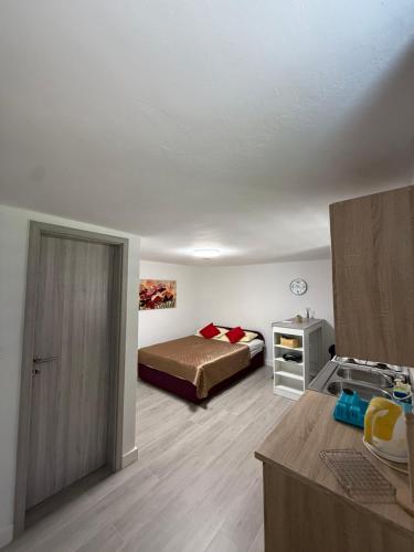 a bedroom with a bed and a table in it at Apartments Šestan in Novalja