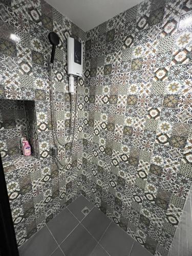 a bathroom with a shower with a tiled wall at The Base Central Phuket-B2-Y9B in Ban Rangeng