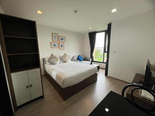 a bedroom with a bed and a television in it at The Base Central Phuket in Phuket